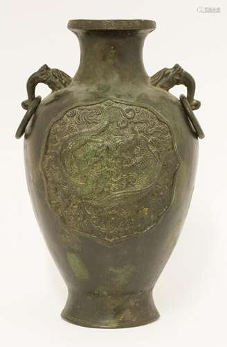 A Chinese bronze vase, 19th century, moulded with two dragons amongst clouds in a shaped panel, two ...