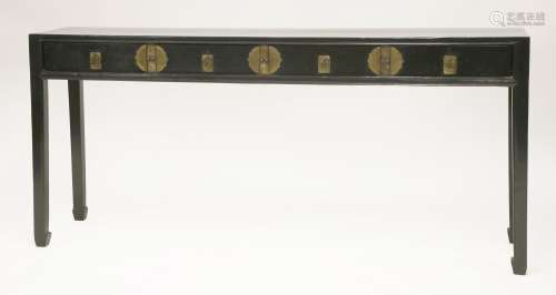 A Chinese black lacquered side table, late 19th century, with four drawers and shaped mounts and ...