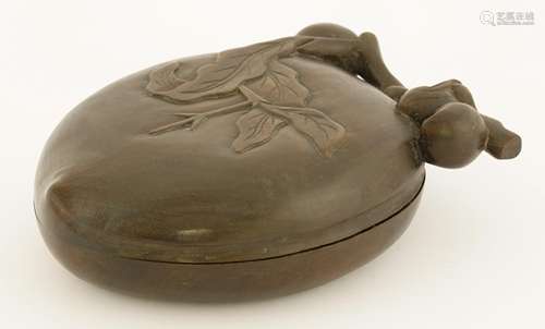 A Chinese inkstone, in the shape of a peach, carved with pomegranates in relief, the reverse with a ...