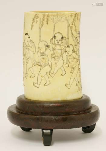 A Japanese ivory vase, Meiji, c.1890, deeply carved with six boys holding bamboo sticks, following ...