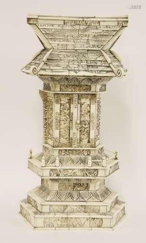 A Japanese ivory shrine, c.1880, of typical form, the central column with hinged doors enclosing ...