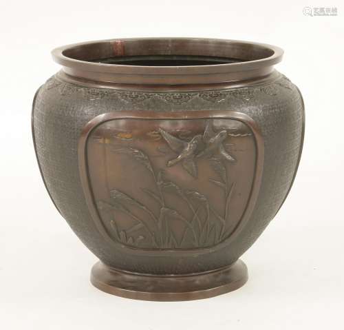 A Japanese bronze jardinière, Meiji period (1868-1912), moulded with shaped panels of magpies with ...
