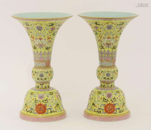 A pair of Chinese famille rose gu vases,  painted with eight Buddhist emblems amongst scrolling ...