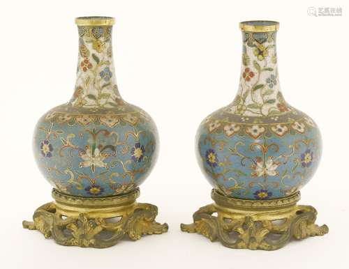 A pair of cloisonné vases, 19th century, each with scrolling lotus and other flowers against a blue ...