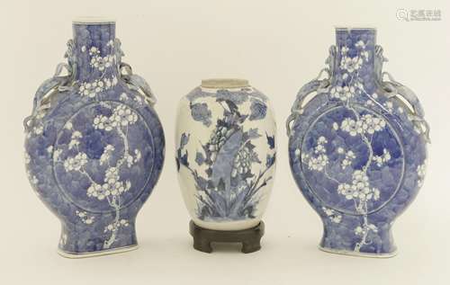 A pair of Chinese blue and white moon flasks, c.1900 and later, painted with blossoming prunus tree ...