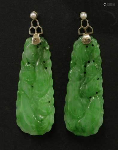 A pair of Chinese jadeite earrings, late Qing dynasty, carved with scrolling tendrils and gourds, ...