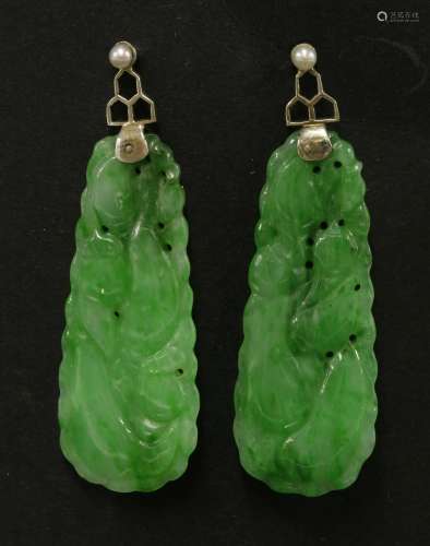 A pair of Chinese jadeite earrings, late Qing dynasty, carved with scrolling tendrils and gourds, ...