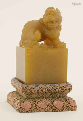 A Chinese soapstone seal, 20th century, carved with a mythical beast seated on a square pedestal, ...