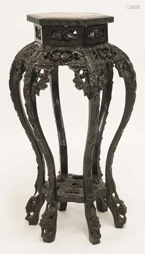 A Chinese ebonised vase stand, c.1900, of hexagonal top inset with rouge marble, supported by ...