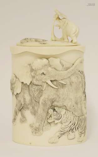 A Japanese ivory box and cover, Meiji period (1868-1912), the raw section of tusk deeply carved in ...