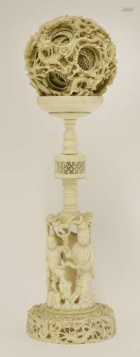 A large Canton ivory ball and stand, late 19th century, the outer sphere pierced and carved with ...
