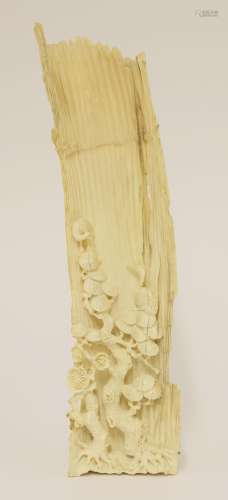 A Chinese ivory wrist rest, 19th century, carved as a section of bamboo with The Three Friends of ...
