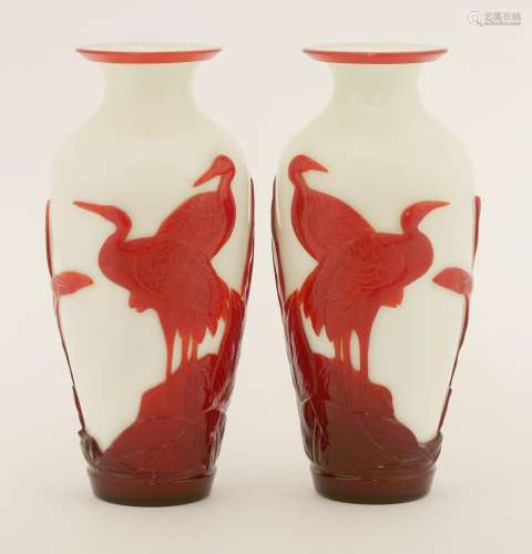 A pair of Chinese overlay Peking glass vases, each decorated in red on a white ground with egrets ...
