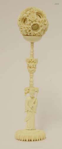 A Canton ivory ball and stand,  late 19th century, the ball exterior carved with blossoming peony, ...