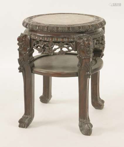A Chinese rosewood vase stand, c.1900, of circular form, pierced and carved with prunus, inset with ...
