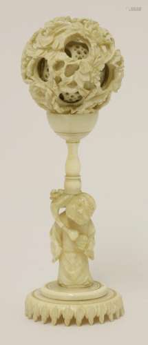 A Canton ivory ball and stand,  late 19th century, the ball exterior carved with peony amongst ...