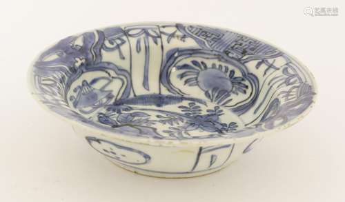 A Chinese blue and white dish, Wanli (1573-1620), painted in Kraak style, with panels of precious ...