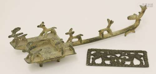 A Chinese bronze candleholder, moulded with deer on a square tray, the handle with a deer finial,  ...