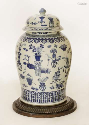 A Chinese blue and white baluster vase and cover, c.1900, painted with precious objects including ...