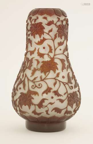 An overlay Peking glass vase, Qing dynasty (1644-1911), the pear-shaped body decorated with ...