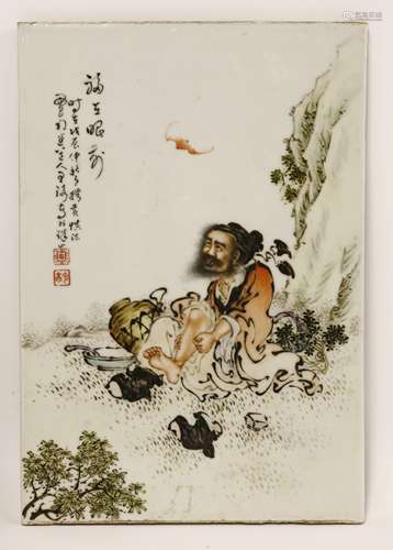 A Chinese ceramic panel, painted with a Daoist immortal resting by a cliff, massaging his leg with ...