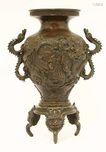 A Japanese bronze vase, Meiji period (1868-1912), cast in relief with a deity standing on the back ...