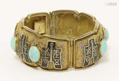 A Chinese silver gilt hinged bangle, 1930s, the mesh ground enamelled with archaic characters on ...