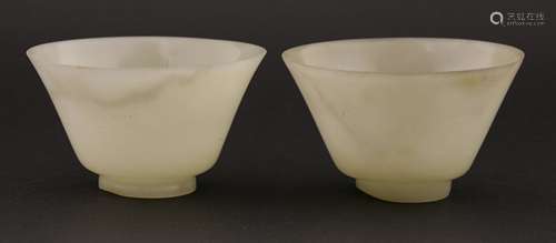 A pair of Chinese jade tea bowls, 20th century, of circular form with spared mouth, 9.2cm diameter ...