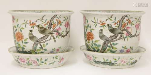A pair of famille rose planters and stands, each painted with birds standing on a pomegranate tree ...