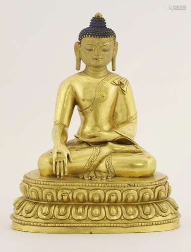 A Chinese gilt bronze Buddha, seated cross-legged on a double lotus pedestal, in Bhumisparsha ...