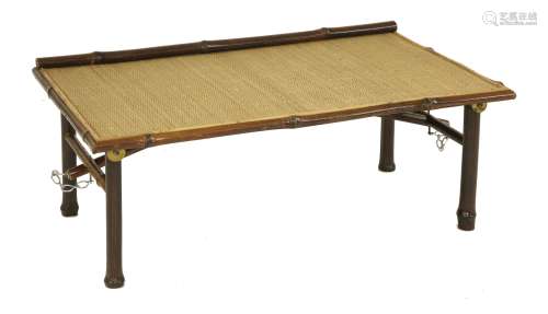 A Chinese folding low table, late 19th century, the rectangular top inset with rattan, the border ...