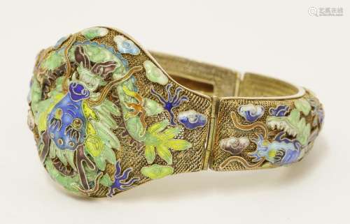 A Chinese silver gilt hinged bangle, 1930s, the mesh ground decorated with dragons amongst clouds ...