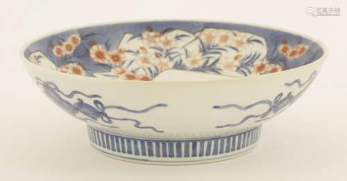 A Japanese Nabeshima dish,  early 19th century, painted with three bouquets of dianthus against a ...