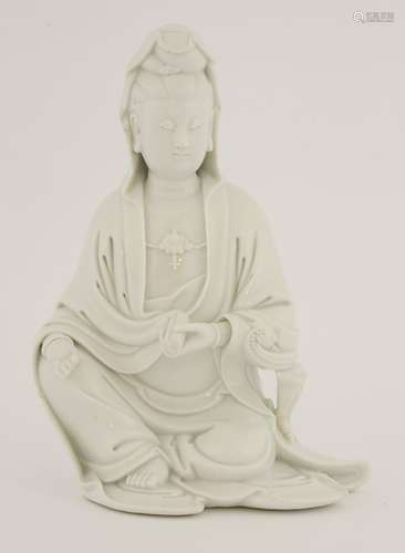 A Chinese blanc de Chine Guanyin, 18th/19th century, seated with his right hand resting on his ...