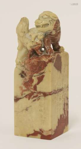 A Chinese soapstone seal, 20th century, of square form, the finial carved with a Buddhist lion and ...