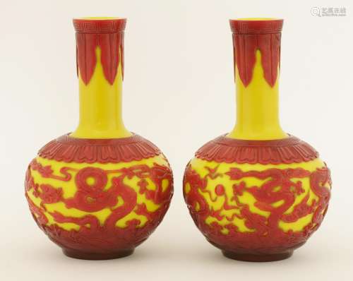 A pair of Chinese overlay Peking glass vases, each of globular form with a long straight neck, ...
