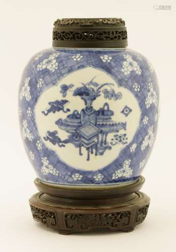 A Chinese blue and white ginger jar, Kangxi (1662-1722), painted with incense burners, vases, books ...