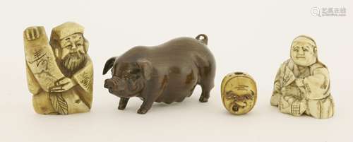 A collection of three Japanese netsuke, c.1900, including a wood pig, a horn Jurogin, an ivory ...