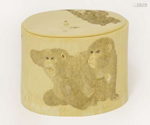 A Japanese ivory box and cover, c.1880, carved in relief with apes chasing flying insects, the ...