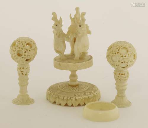 Two Canton ivory balls on stand, late 19th century, each exterior carved with scrolling flowers, on ...