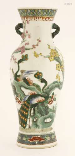 A Chinese famille rose vase, late Qing dynasty, painted with two peacocks by two blossoming trees, ...