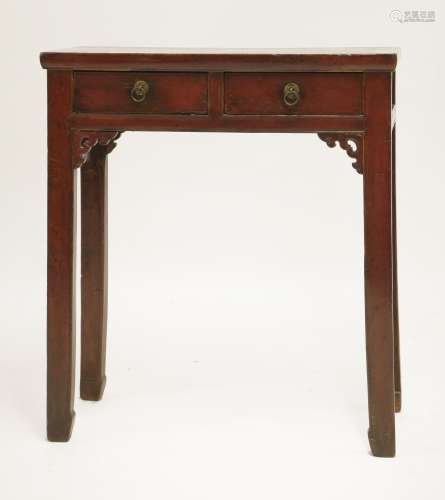 A Chinese red lacquered coffer table, early 20th century, with two drawers above a pierced and ...