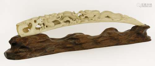 A Chinese ivory carving, c.1920, with two dragons amongst waves,  53.5cm, wood stand (2)  民国约1920年 ...