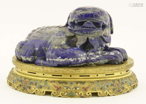 A Chinese lapis lazuli group, modern, carved with a Buddhist lion with his pup, their fur engraved ...