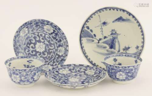 A pair of Chinese porcelain blue and white tea bowls and saucers, Kangxi (1662-1722), painted with ...