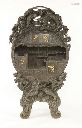 A Japanese carved blackwood cabinet, Meiji period (1868-1912), of circular form carved with ...