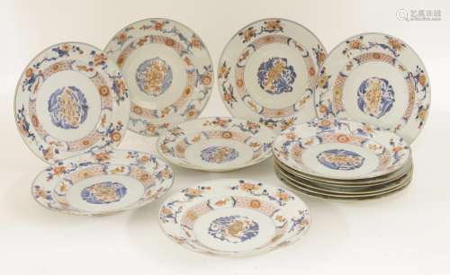 A set of thirteen Chinese Imari plates, c.1730, painted with sprigs of flowers encircled by a ...