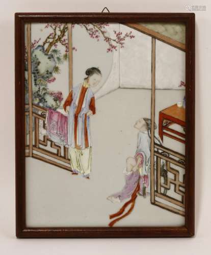 A Chinese famille rose ceramic plaque, Qianlong (1736-1795), painted with a couple putting their ...