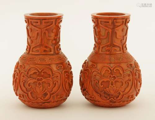 A pair of Chinese Peking glass vases, each coral-red globular body decorated with scrolling lotus ...