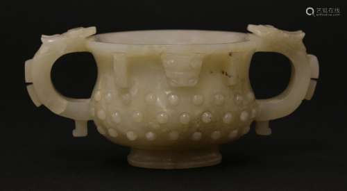 A Chinese jade two-handled cup, Ming dynasty (1368-1644), of circular form carved with studs, the ...